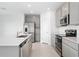 Bright kitchen featuring stainless steel appliances and ample counter space at 606 Bell Prairie Cir, Lake Wales, FL 33859