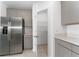 Modern kitchen with stainless steel refrigerator and pantry access at 606 Bell Prairie Cir, Lake Wales, FL 33859