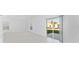 Bright open space with tile flooring and sliding glass door view of the yard at 606 Bell Prairie Cir, Lake Wales, FL 33859