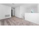 Carpeted loft area with natural light and neutral colors at 606 Bell Prairie Cir, Lake Wales, FL 33859