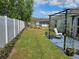A spacious backyard with a well-maintained lawn, fence, and landscaping at 633 Kangaroo Dr, Kissimmee, FL 34759