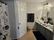 Modern bathroom with vessel sink, vanity, tiled floors, and a decorative shower curtain at 633 Kangaroo Dr, Kissimmee, FL 34759