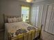 Bright bedroom featuring a brass bed frame and double closets at 633 Kangaroo Dr, Kissimmee, FL 34759