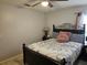 Comfortable bedroom with a decorative wrought iron bed frame, side table and lamp at 633 Kangaroo Dr, Kissimmee, FL 34759