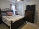 Cozy bedroom with a decorative wrought iron bed frame, dresser, and light-colored tile floors at 633 Kangaroo Dr, Kissimmee, FL 34759