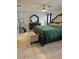 Relaxing bedroom features a large bed, bench, and a matching wood dresser with mirror at 633 Kangaroo Dr, Kissimmee, FL 34759