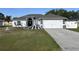 Charming single-story home with well-maintained lawn, inviting entrance and two car garage at 633 Kangaroo Dr, Kissimmee, FL 34759