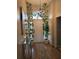 Welcoming foyer featuring a decorative chandelier, console table, and tiled flooring at 633 Kangaroo Dr, Kissimmee, FL 34759