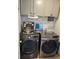 Well-organized laundry room featuring modern washer and dryer sets at 633 Kangaroo Dr, Kissimmee, FL 34759