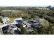 An aerial view shows a residential neighborhood with screened-in pools, solar panels, and lush landscaping at 802 Suffolk Pl, Davenport, FL 33896