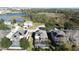An aerial view shows a residential neighborhood with screened-in pools, solar panels, and lush landscaping at 802 Suffolk Pl, Davenport, FL 33896