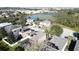 Aerial view showcases houses with screened patios and a lake, in a residential community at 802 Suffolk Pl, Davenport, FL 33896