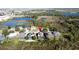 Aerial view showcases houses with screened patios and a lake, in a residential community with a red pin marking a property at 802 Suffolk Pl, Davenport, FL 33896