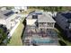 Aerial view of a backyard features a screened-in pool, patio, and solar panels, ideal for outdoor entertaining at 802 Suffolk Pl, Davenport, FL 33896