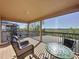 Relaxing covered balcony with comfortable seating and scenic views of the surrounding landscape at 802 Suffolk Pl, Davenport, FL 33896