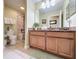 Bathroom featuring granite countertops, decorative mirrors, and a separate shower and tub at 802 Suffolk Pl, Davenport, FL 33896