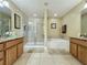 Bathroom with a large walk-in shower, soaking tub, and individual sinks with granite countertops at 802 Suffolk Pl, Davenport, FL 33896