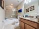 Tiled bathroom with shower and bath, vanity with sink, and a neutral color palette at 802 Suffolk Pl, Davenport, FL 33896