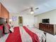 A bedroom boasts a TV and dresser with an ensuite bathroom and closet at 802 Suffolk Pl, Davenport, FL 33896