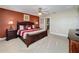 Bedroom with decorative lamps on each side of the bed and with attached bathroom and view of the backyard at 802 Suffolk Pl, Davenport, FL 33896