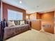 Loft bedroom with daybed, soft carpet, and bright natural light from the window at 802 Suffolk Pl, Davenport, FL 33896