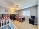 Shared bedroom with carpet, ceiling fan, and space for a crib or playroom setup at 802 Suffolk Pl, Davenport, FL 33896