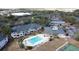 Overhead shot of a community with a sparkling pool, tennis courts, and ample parking at 802 Suffolk Pl, Davenport, FL 33896