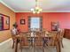 Elegant dining room with a wooden table, seating for eight, and stylish decor at 802 Suffolk Pl, Davenport, FL 33896
