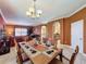 Dining room with a wooden table, seating for eight, and opens to living spaces at 802 Suffolk Pl, Davenport, FL 33896