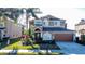 Charming two-story home with lush landscaping, a driveway, and a two-car garage at 802 Suffolk Pl, Davenport, FL 33896