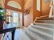 Inviting foyer with staircase and decorative elements, showcasing a warm welcome at 802 Suffolk Pl, Davenport, FL 33896