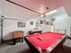 Finished garage game room features a pool table, foosball table, and an air hockey table, perfect for entertaining guests at 802 Suffolk Pl, Davenport, FL 33896