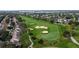 Scenic aerial view of the community golf course featuring lush green fairways and mature trees at 802 Suffolk Pl, Davenport, FL 33896