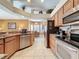 Spacious kitchen with granite countertops, stainless appliances and a view of the living areas at 802 Suffolk Pl, Davenport, FL 33896
