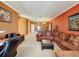 Inviting living room with plush sofa, stylish decor, and an adjoining dining area at 802 Suffolk Pl, Davenport, FL 33896