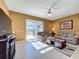Comfortable living room with tile floors and sliding glass doors with pool view at 802 Suffolk Pl, Davenport, FL 33896