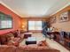 Inviting living room features a plush sofa, office area, and neutral carpet at 802 Suffolk Pl, Davenport, FL 33896