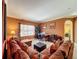 Inviting living room features a plush sofa, office area, and neutral carpet at 802 Suffolk Pl, Davenport, FL 33896