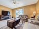 Relaxing living room with ceiling fan, television and sliding glass doors at 802 Suffolk Pl, Davenport, FL 33896