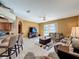 Open living room with tile floors and access to the pool area; comfortable and inviting at 802 Suffolk Pl, Davenport, FL 33896