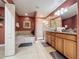 Spacious main bathroom with soaking tub, separate shower, double sink vanity, and tile flooring at 802 Suffolk Pl, Davenport, FL 33896