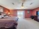 Main bedroom with large bed, balcony access, ceiling fan, and ensuite bathroom at 802 Suffolk Pl, Davenport, FL 33896