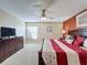 Spacious main bedroom featuring a large bed, dresser, and abundant natural light from the window at 802 Suffolk Pl, Davenport, FL 33896