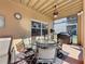Covered outdoor dining area with ceiling fan, creating a comfortable space to relax and grill at 802 Suffolk Pl, Davenport, FL 33896