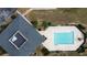 Aerial view showcasing a beautiful community pool with lounge chairs, all surrounded by well-maintained landscaping at 802 Suffolk Pl, Davenport, FL 33896