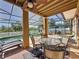 Spacious screened-in pool area with multiple seating arrangements, perfect for outdoor living at 802 Suffolk Pl, Davenport, FL 33896