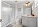 Bathroom featuring a glass-enclosed shower and a vanity with ample storage at 8517 Crystal Cove Loop, Kissimmee, FL 34747