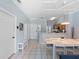 Open concept dining area featuring a white table, seating for six, and access to the kitchen at 8517 Crystal Cove Loop, Kissimmee, FL 34747