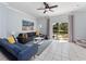 An inviting living room features a large sectional sofa, open sliding glass doors, and pond views at 8517 Crystal Cove Loop, Kissimmee, FL 34747