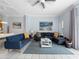 Airy living room features modern sofas, a large sectional, stylish decor, and white tile flooring at 8517 Crystal Cove Loop, Kissimmee, FL 34747